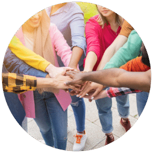 A diverse group of eleven people put their hands in for a high 5